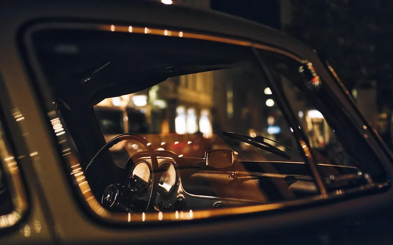 Parked classic car seen through its side window at night Parked classic car seen through its side window at night