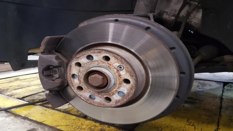 Close-up of a car brake disc rotor mounted on a wheel hub