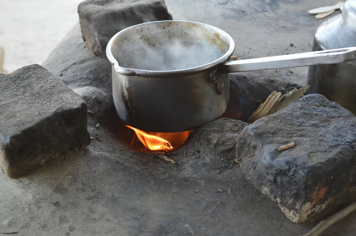 Portable gas stove burner in use during outdoor cooking