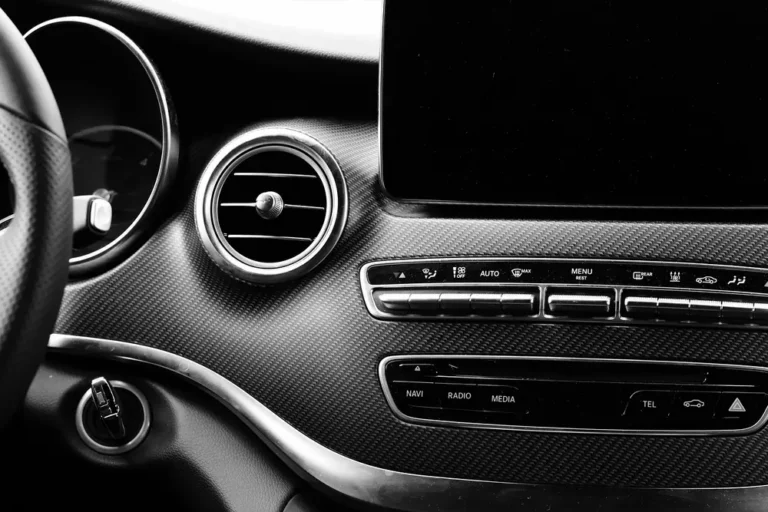 Car dashboard air vent and climate control buttons in black and white