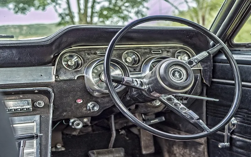 Car chassis underside showing frame rails and suspension mounting points