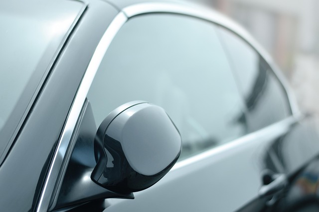car window tint film being applied to car window with squeegee