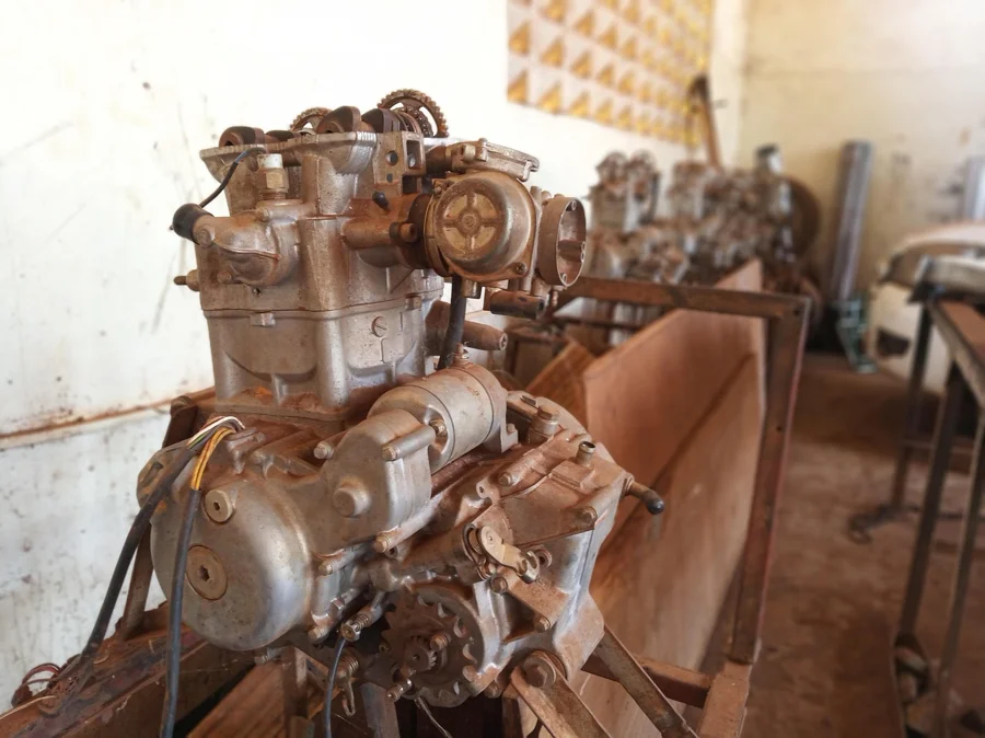 An engine removed and set on a workbench for inspection and cleaning