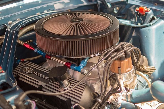 Mechanic inspecting a car engine bay for a coolant leak