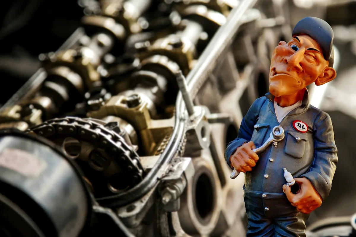 Mechanic working on a car engine, the kind of job that often includes a coolant system flush
