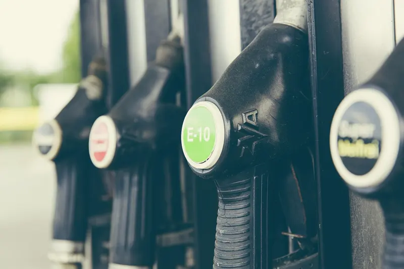 Row of fuel pump nozzles with one handle labeled E-10