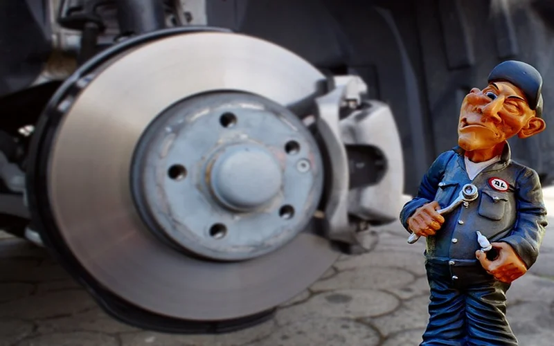 Brake rotor inspection for squeaky brake diagnosis — checking for rust, wear, and pad thickness