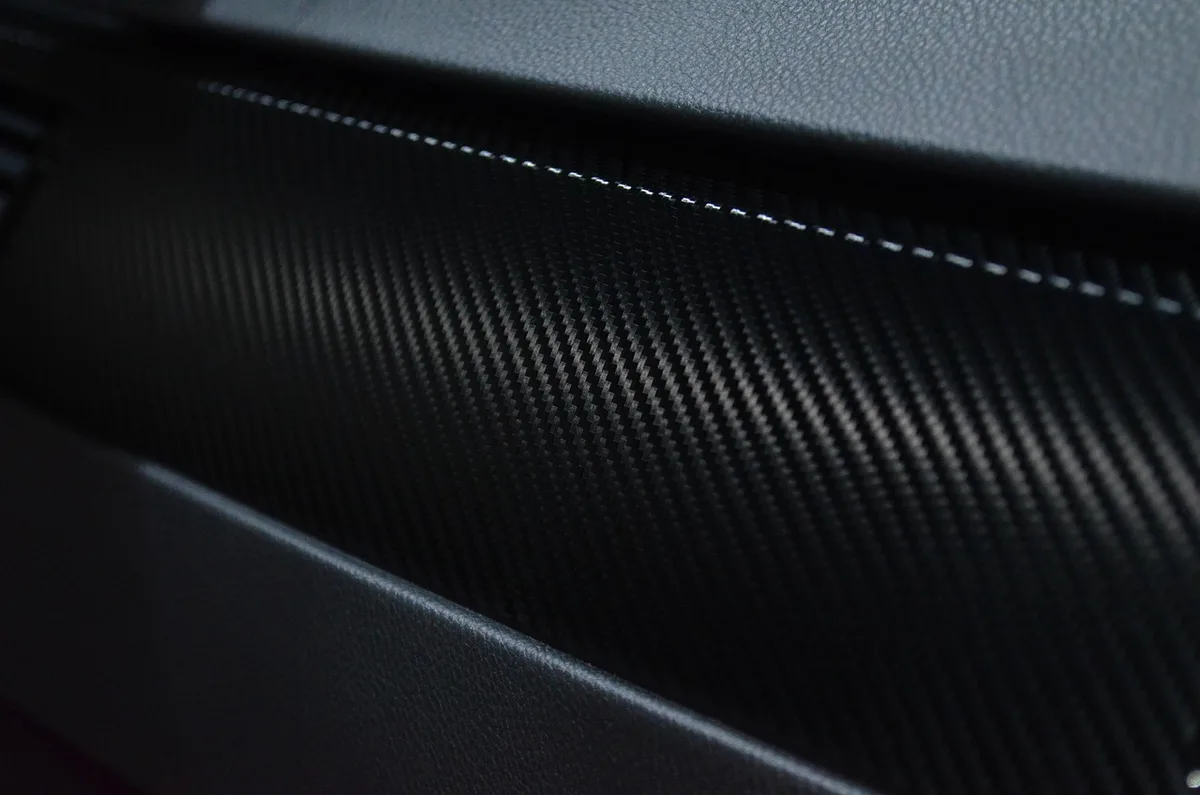 Clear automotive film being applied to a car body panel