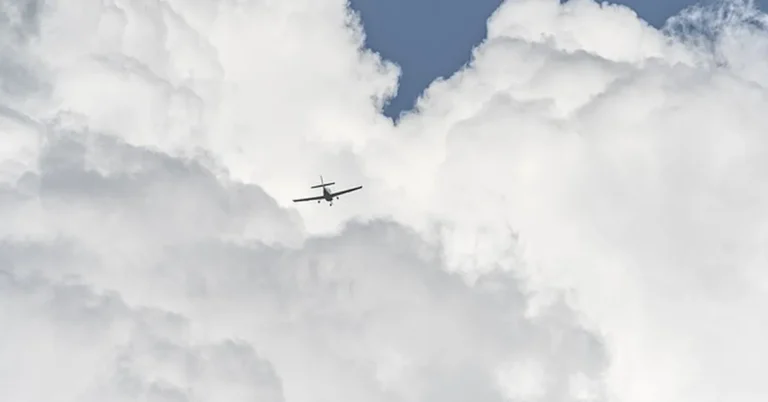 Small commercial airplane flying through clouds