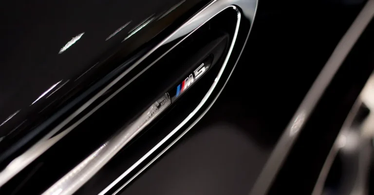 BMW Black Sapphire Metallic badge and body panel with metallic shine