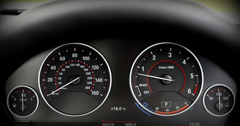 BMW instrument cluster showing speedometer and tachometer gauges where warning messages appear