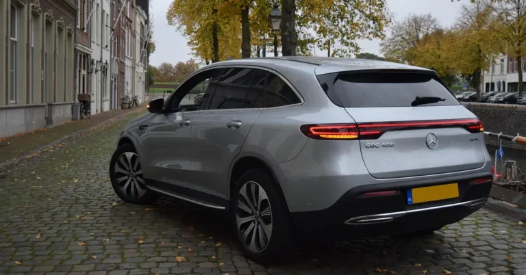Silver electric luxury SUV parked on a cobblestone street, representing the EV SUV segment
