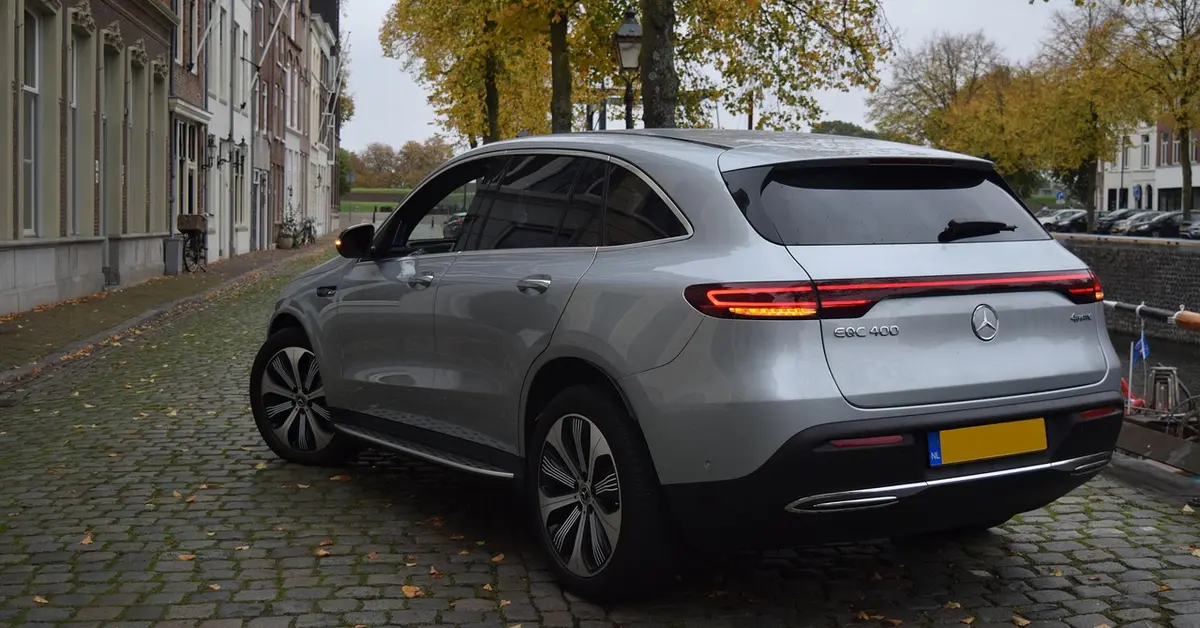 Silver electric luxury SUV parked on a cobblestone street, representing the EV SUV segment