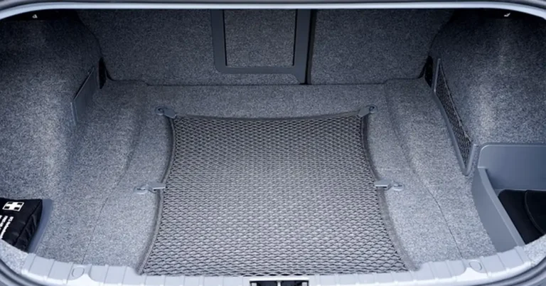 Empty car trunk cargo area with the retractable cargo net, similar to a BMW X3 trunk