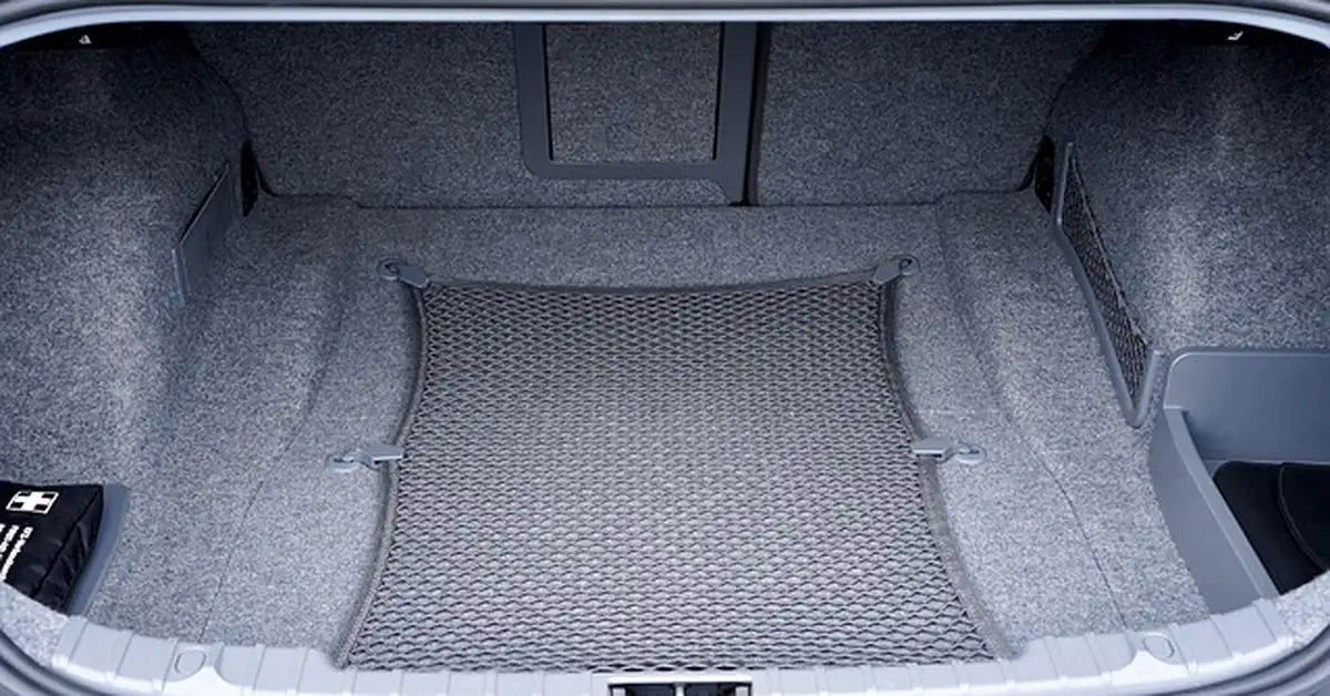 Empty car trunk cargo area with the retractable cargo net, similar to a BMW X3 trunk