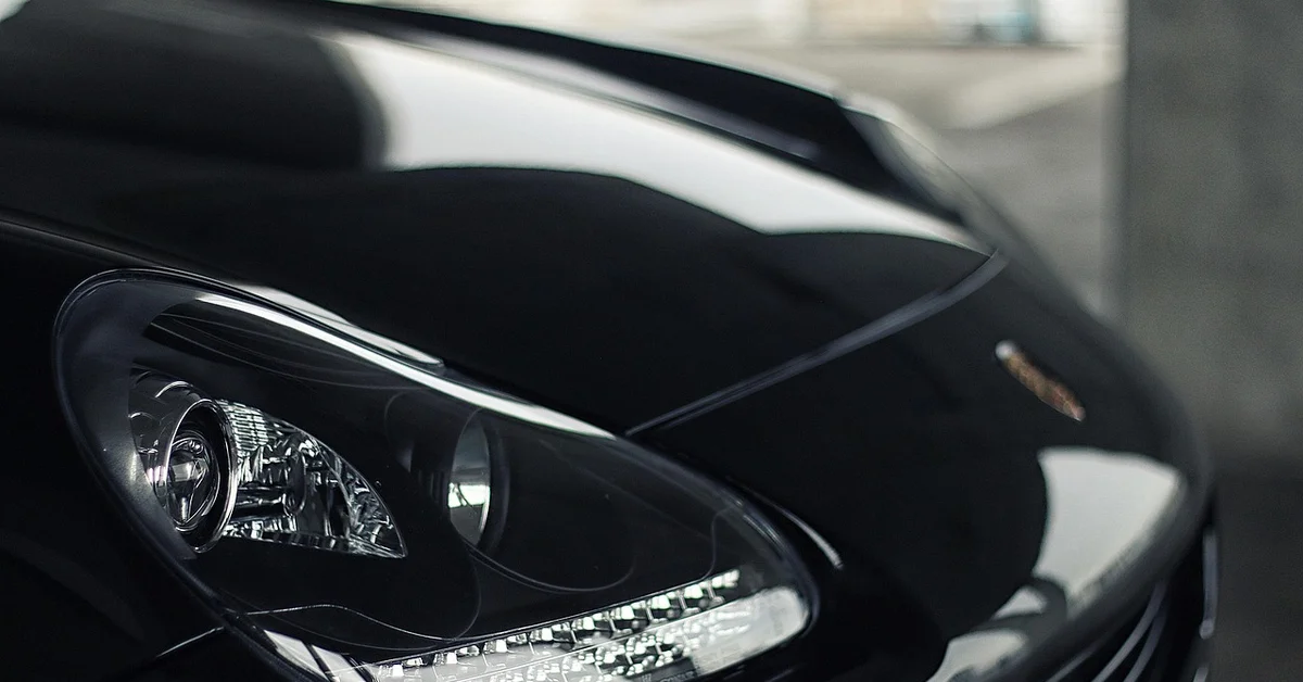 Black luxury SUV headlight and hood detail comparing BMW X3 and Acura MDX