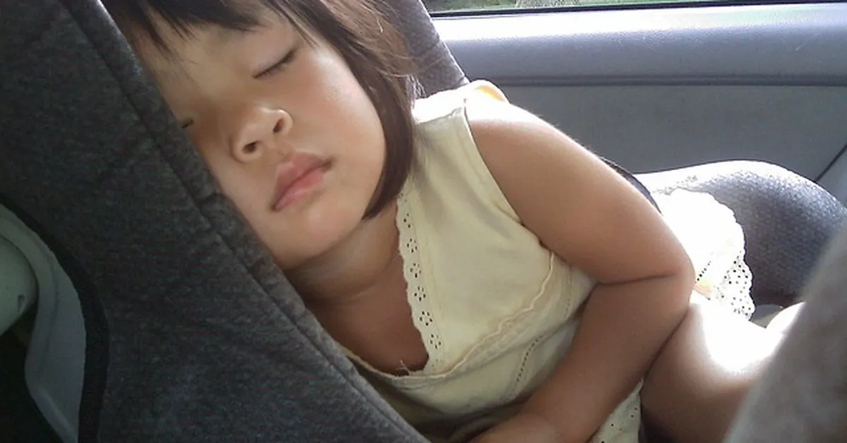 Toddler asleep in a used car seat that meets safety standards