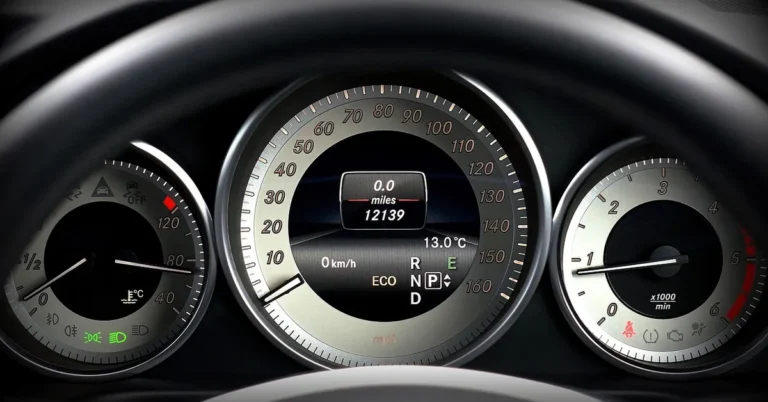 Close-up of a car dashboard showing the odometer and mileage