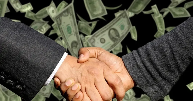 Car buyer and dealer shaking hands over a deal