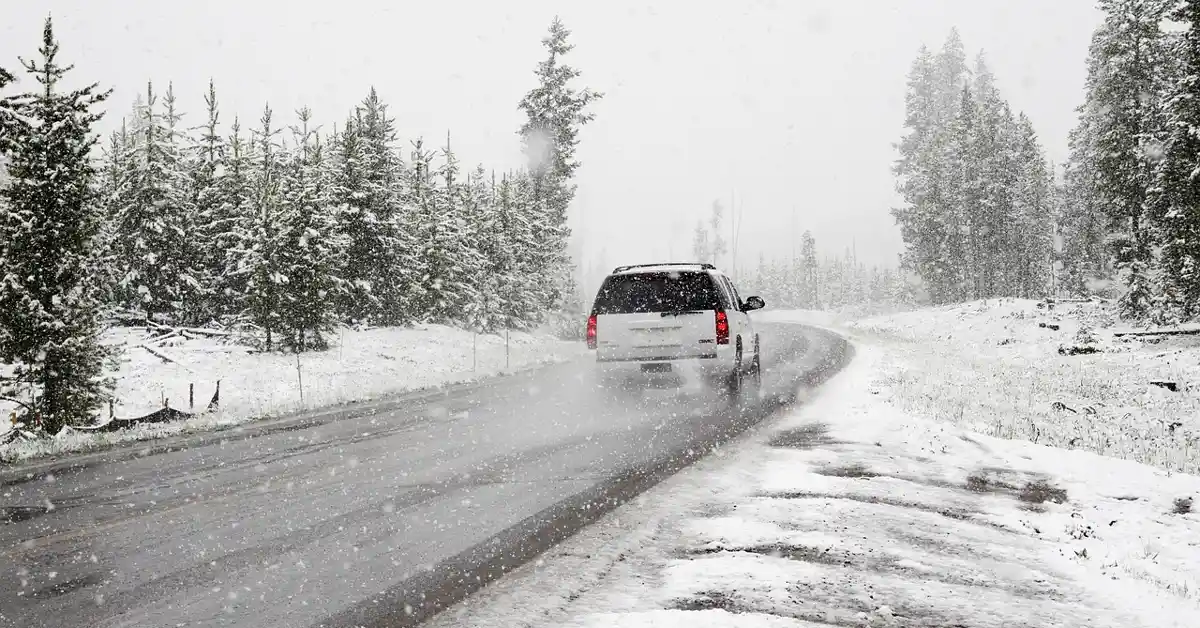 Car driving on a snowy winter road