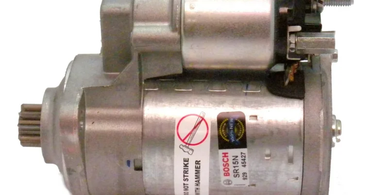 Car starter motor removed from the engine