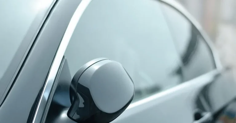 Close-up of a car window with dark tint film