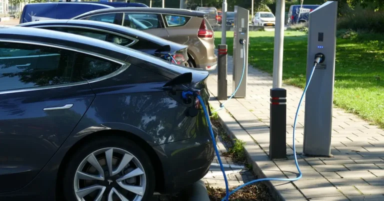 Electric vehicle plugged into a public charging station similar to how a Chevy Bolt EV charges
