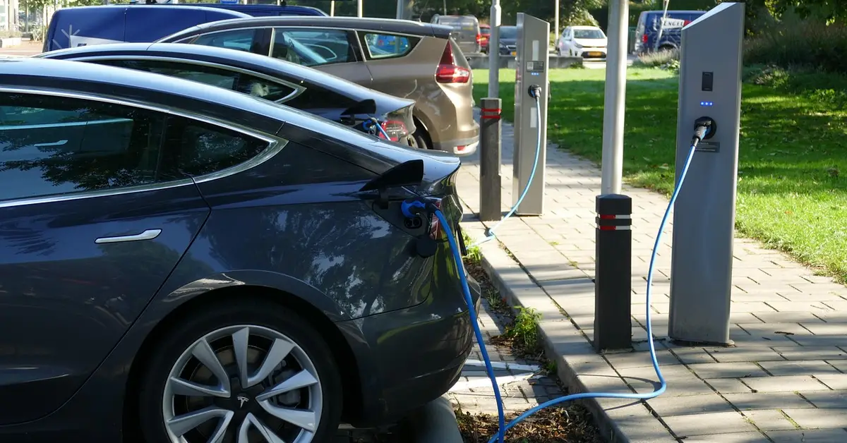 Electric vehicle plugged into a public charging station similar to how a Chevy Bolt EV charges