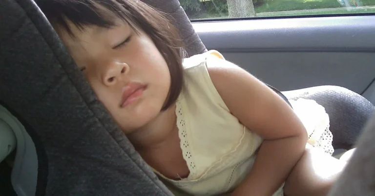 Child sleeping safely in a car seat