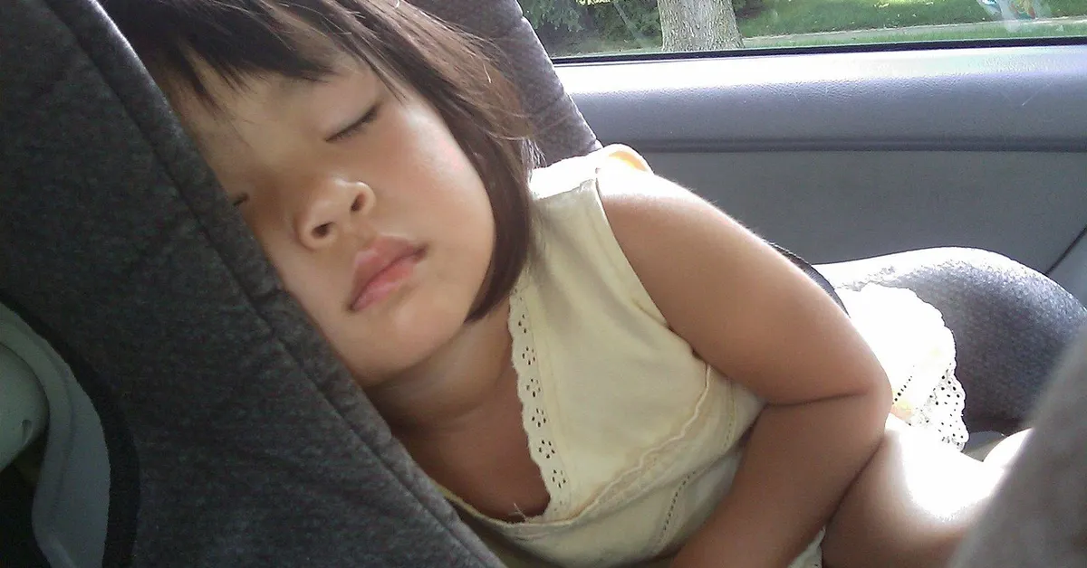 Child sleeping safely in a car seat