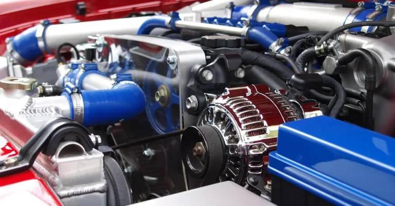 Close-up of a car engine bay showing cylinder head and belt components