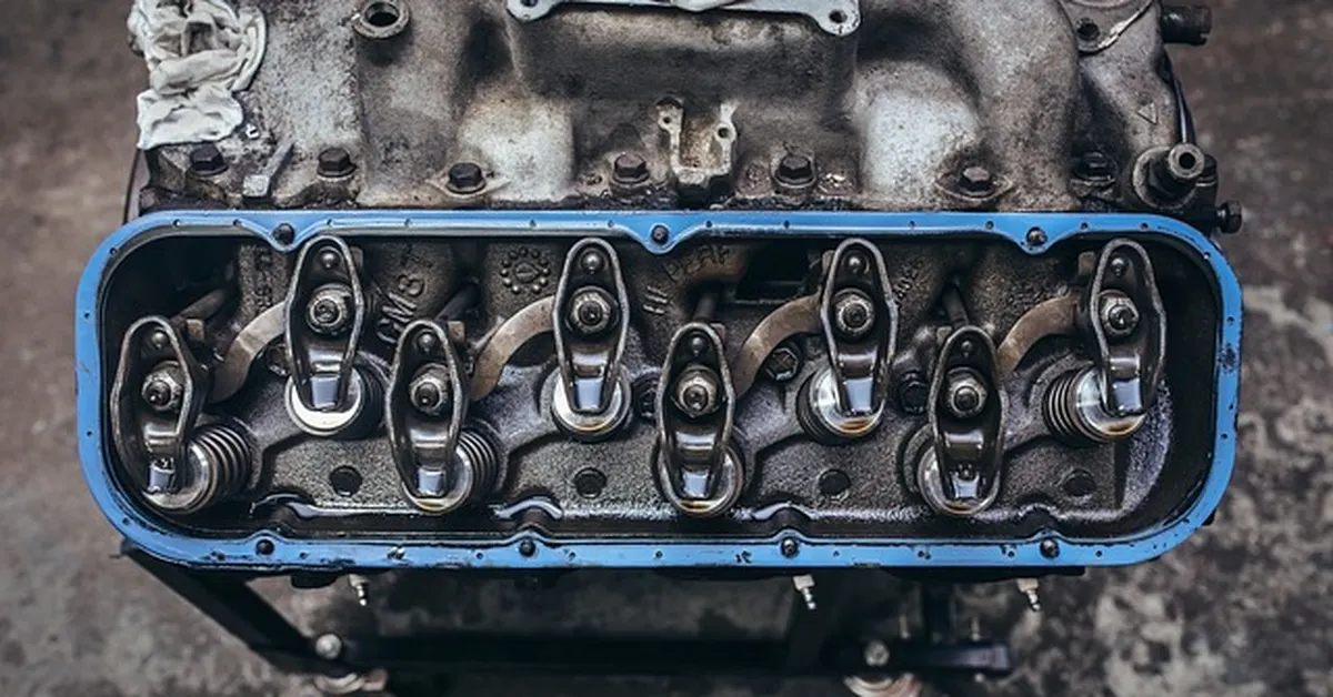 Close-up of an engine valve cover showing oil lubrication points
