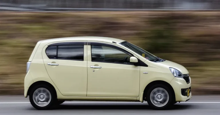 A small compact car driving on a road, representing the compact car size class
