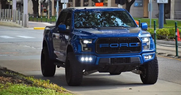 Blue metallic Ford F-150 Raptor truck showing a deep navy blue paint finish