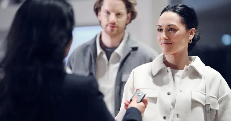 Car buyer receiving keys during a purchase, representing a used Ford Edge or new Hyundai Tucson deal