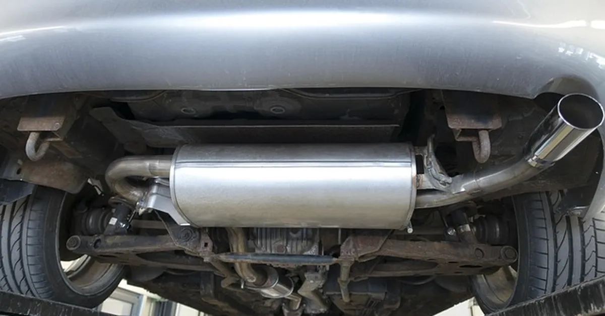Underside view of a vehicle exhaust system and muffler where oxygen sensors are mounted