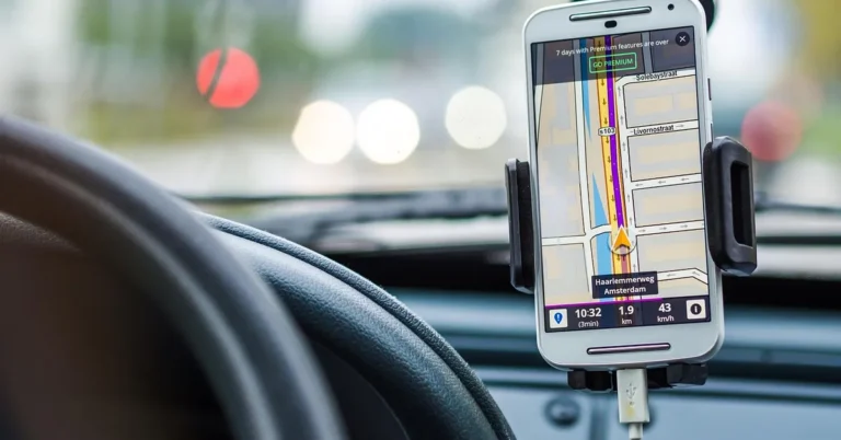 Smartphone GPS navigation mounted on car dashboard tracking location