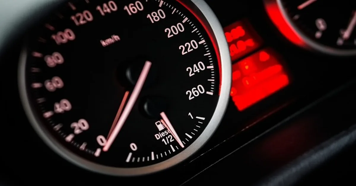 Close-up of a car dashboard speedometer and warning light cluster