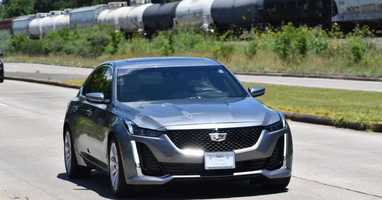 Modern silver sedan on the road, representing compact hybrid trim comparison