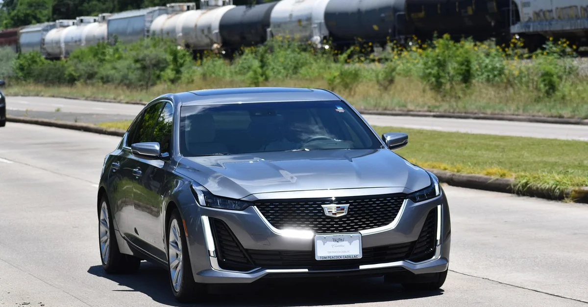 Modern silver sedan on the road, representing compact hybrid trim comparison