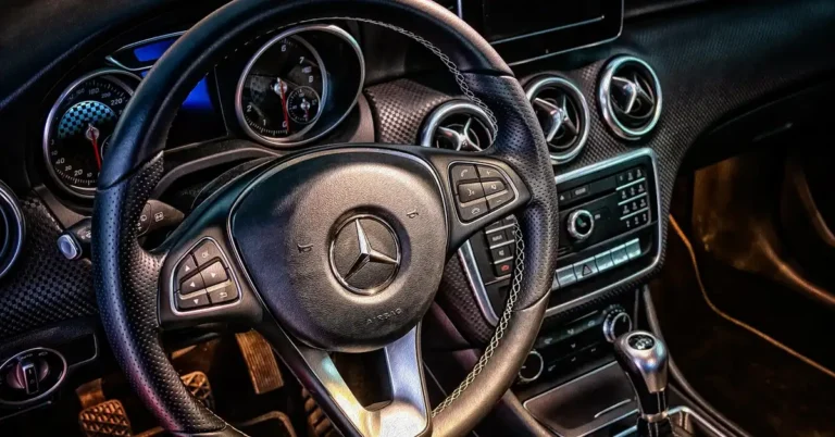 Car dashboard and steering wheel with horn controls