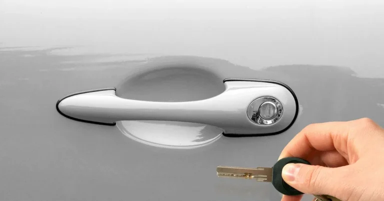 Hand unlocking a car door with a rental car key