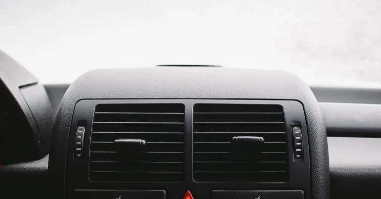 Close-up of a car dashboard with the hazard warning light button