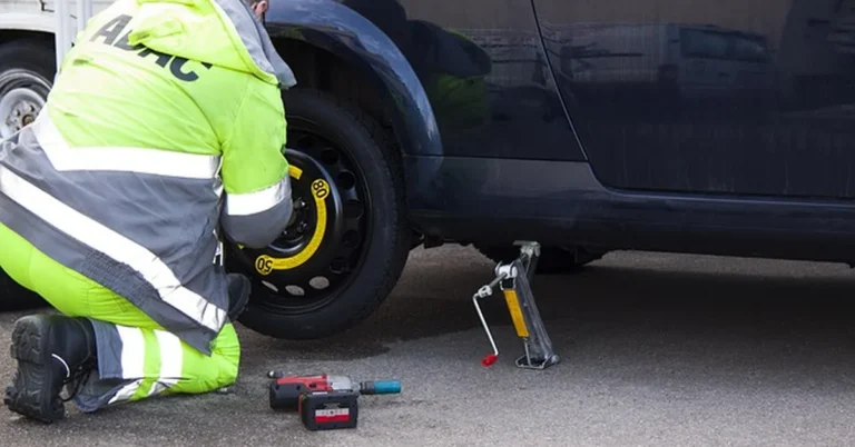 Mechanic changing a tire roadside