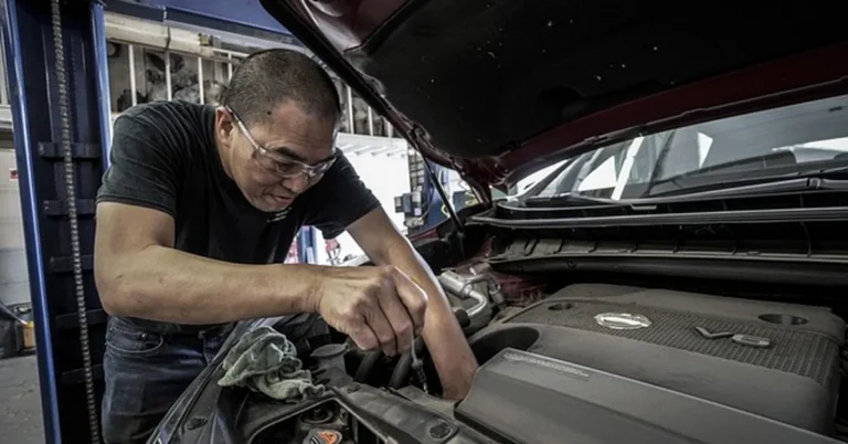 Mechanic servicing a car engine