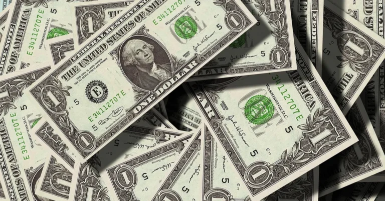 Stack of dollar bills representing extra car loan payments