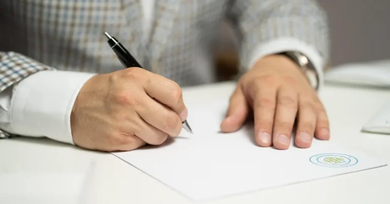 Signing a car insurance policy document