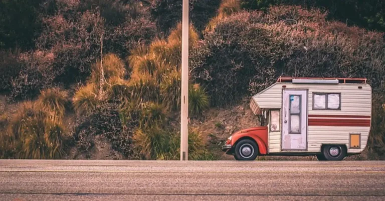 Travel trailer camper being towed at sunset