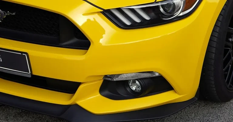 Closeup of glossy car front bumper and clear coat paint