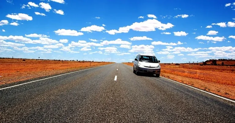 Rental car driving on a long empty highway